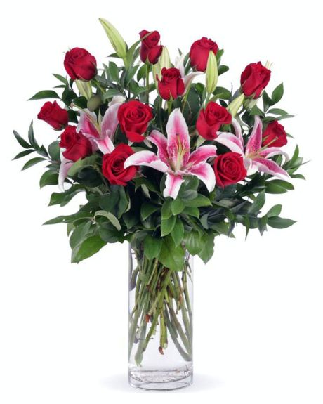 ROSE PARADE-This romantic arrangement of stargazer lilies, red roses and garden greens will help to celebrate your occasion with style. Made with #1 Grade ,Ecuadorian, Explorer Red Roses,  and California grown lilies. rOSE ARRANGEMENT