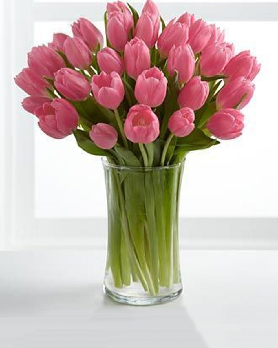 Passionate Pink Tulips Deluxe-30 Tulips Fresh from Holland, our tulips are artistically designed in a chic glass vase accented with willow and flair of dramatic river grass.
DELIVERY: Every order is hand-delivered direct to the recipient. These items will be delivered by us locally, or a qualified retail local florist.