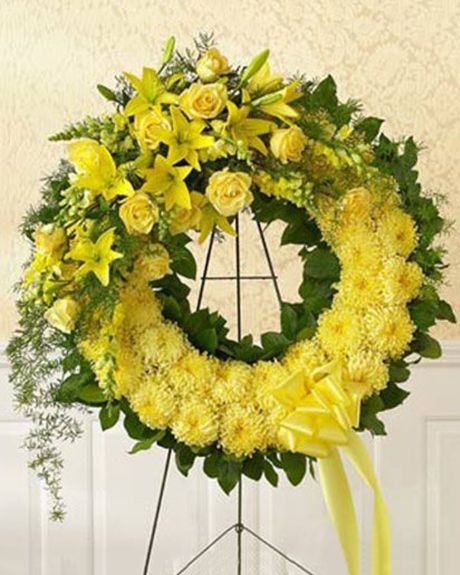 Ring of the Spirit-This stunning wreath is consisting of
* Single-colored flowers such as mums, snapdragons and lilies are accented with monte casino, springeri and salal.-Sympathy Wreath