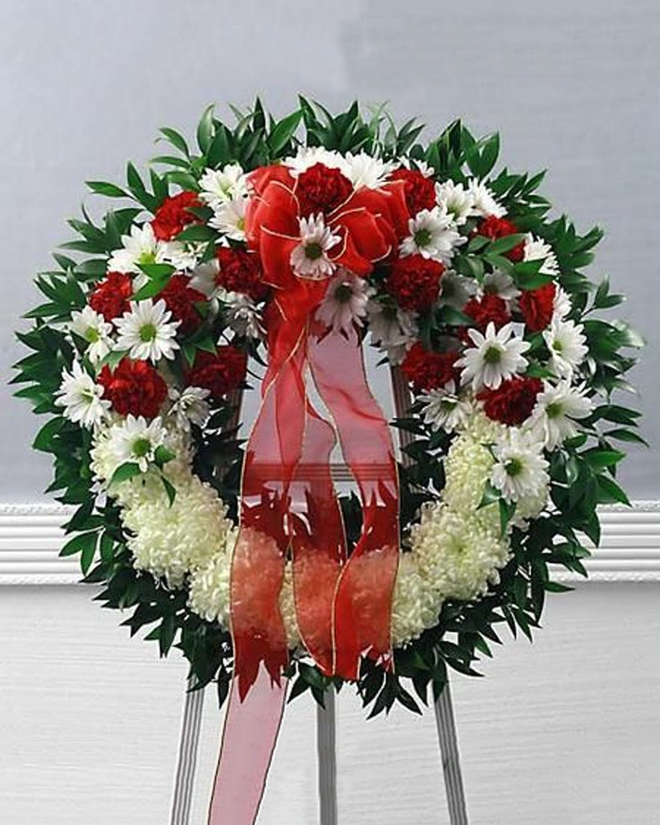Royal Tribute Deluxe (24 Inch) Red and white flowers nestled together to form this elegant wreath. This arrangement will allow you to express your deepest sympathies to family and loved ones.
DELIVERY: Every order is hand-delivered direct to the recipient. These items will be delivered by us locally, or a qualified retail local florist.