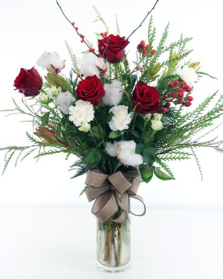 Cali  Christmas-assorted white flowers, red flowers, winter foliage are arranged in a vase.-hristmas Arrangement