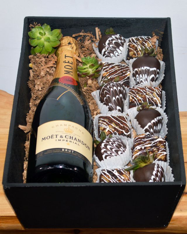 Champagne, Strawberries, And Brownies Fresh, Mouth watering chocolate brownies and irrisistable chocolate covered strawberries are paired with Wine or Champagne of your choice and crafted inside a gift wooden box. The brownies and chocolate covered strawberries are made daily by Babbette Bakery, one of Long beach's finest and oldest bakeries.
Please give at least a 24 hour notice when ordering these products. This helps insure the freshness and quality. The brownies contain nuts.
DELIVERY: Every order is hand-delivered direct to the recipient. This item is only deliverable to local areas serviced by Allen’s Flower Market Stores. 