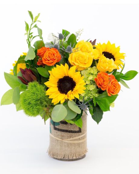 Harvest-Lush colors of the season are captured in this stunning assortment of sunflowers, roses, hydrangea and thistle.  Each arrangement comes uniquely wrapped in a burlap wrapped glass vase.  vase Arrangement
