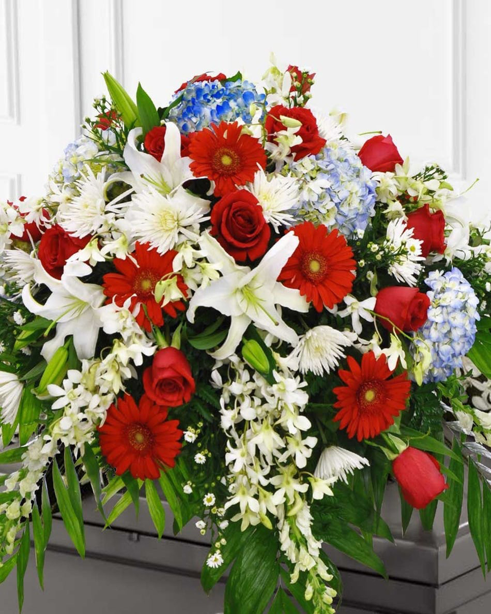 Let Freedom Ring Half Casket Spray-Standard The fight for life, liberty, and the pursuit of happiness is represented in this patriotic spray. Honor will be bestowed upon your loved one by flowers symbolic of the American flag.
DELIVERY: Every order is hand-delivered direct to the recipient. These items will be delivered by us locally, or a qualified retail local florist.