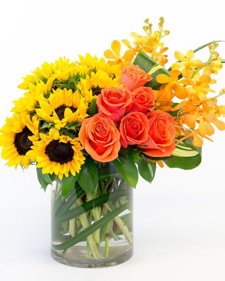 Dawn-Gorgeous sunflowers, stunning roses, and delicate macara orchids combine to make this an arrangement that is sure to brighten anyone's day-cylonder arrangement